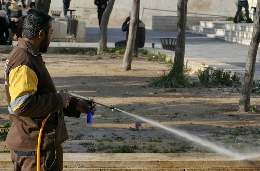 Man using a pressure washer to clean outdoor surfaces, demonstrating exterior cleaning services relevant to Frater Exterior Cleaning Services.